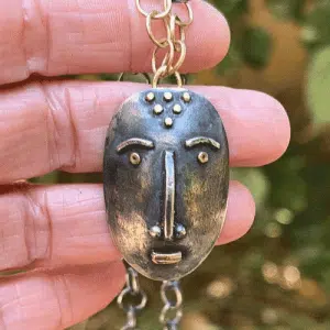 Handmade artisan face silver & 14 karat gold necklace