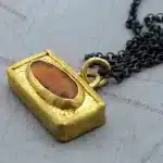 Red gold pendant of silver necklace