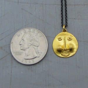 22k gold pendant shaped as ethnic face