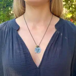 22 karat gold and silver primitive face necklace