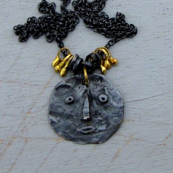 22 karat gold and silver primitive face necklace