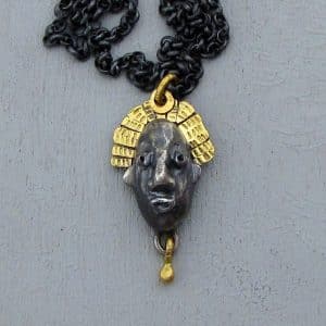 22 karat gold and silver crown face necklace
