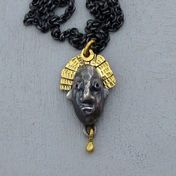 22 karat gold and silver crown face necklace