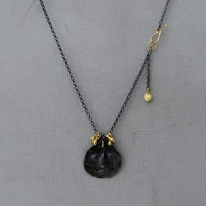 22 karat gold and silver primitive face necklace