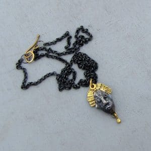 22 karat gold and silver crown face necklace