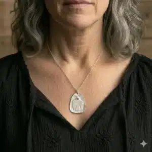 Handmade textured artisan silver necklace with pink eye bird
