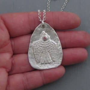 Handmade textured artisan silver necklace with pink eye bird