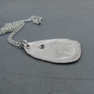 Handmade textured artisan silver necklace with pink eye bird