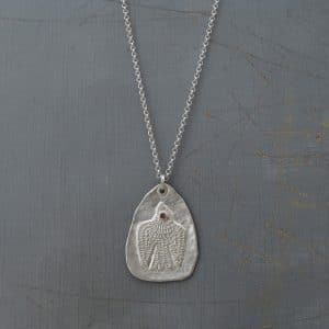 Handmade textured artisan silver necklace with pink eye bird
