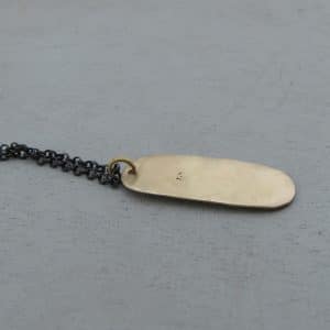 Rectangle 24k gold pendant on a silver chain